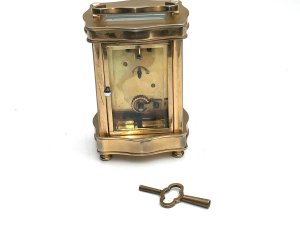 Clock comes in good working order all sections of glass are very good porcelain dial has small damage bottom left corner facing, height to top of extended handle 16cm width 8cm depth being 7cm, reference sb