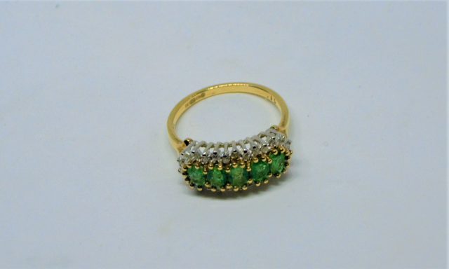 A 9ct Gold Five Emerald and Diamond Ring.
