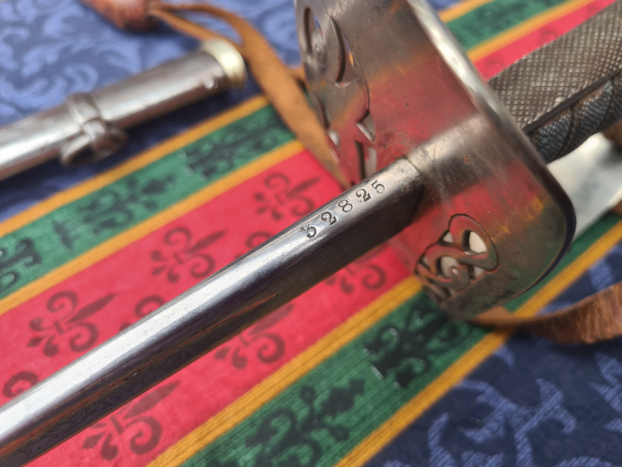 Explore an authentic piece of history with our 1892 pattern 64th Indian Pioneers Infantry Sword inclusive of its original dress, field leather scabbard, and sword bag. A timeless treasure with minor signs of age; more photos available on request.