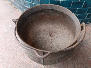 A medium size of cast iron cauldron with 3 legs. Probably 19th century or earlier.  Size 25.5 cm across.