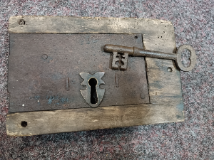 Discover our collection of 19th century iron locks. This feature includes a well-preserved lock in wooden surround with a key. Shop now online for a unique piece of history.