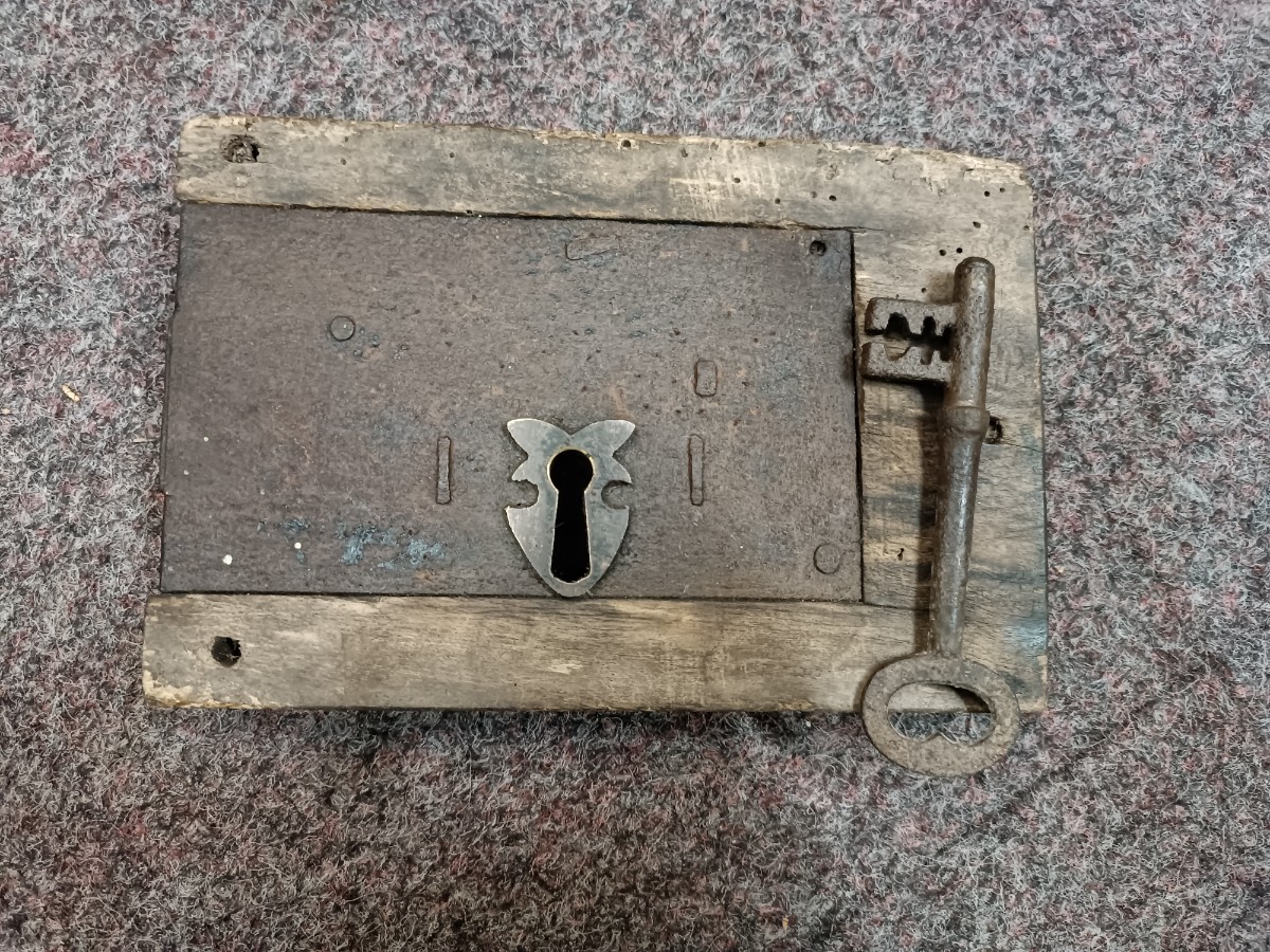 Discover our collection of 19th century iron locks. This feature includes a well-preserved lock in wooden surround with a key. Shop now online for a unique piece of history.