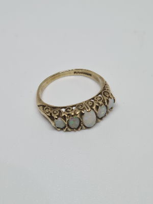 Discover our 9ct gold ring set with 5 opal stones. Featuring Birmingham hallmarks, weighing 3.3 grams, and sized N. Shop now for luxury jewelry!