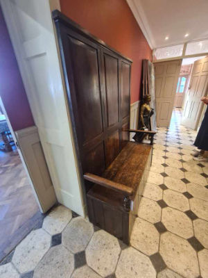 Discover our exquisite Georgian high panel-backed settle with a hinged plank seat. Its size of 178cm high, 140cm wide, and 48cm deep makes a statement. Order now and get it delivered via Proovia courier.