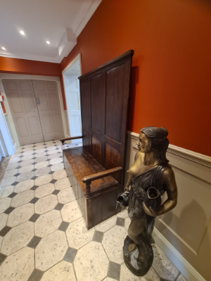 Discover our exquisite Georgian high panel-backed settle with a hinged plank seat. Its size of 178cm high, 140cm wide, and 48cm deep makes a statement. Order now and get it delivered via Proovia courier.