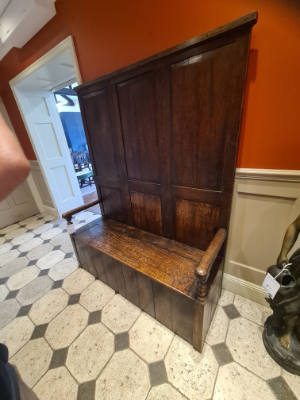 Discover our exquisite Georgian high panel-backed settle with a hinged plank seat. Its size of 178cm high, 140cm wide, and 48cm deep makes a statement. Order now and get it delivered via Proovia courier.