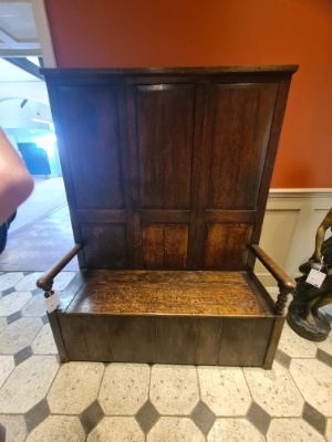 Discover our exquisite Georgian high panel-backed settle with a hinged plank seat. Its size of 178cm high, 140cm wide, and 48cm deep makes a statement. Order now and get it delivered via Proovia courier.