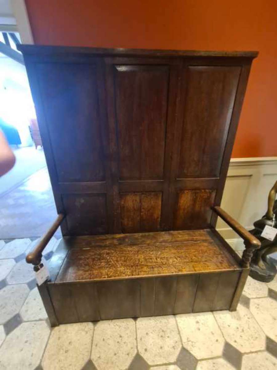 Discover our exquisite Georgian high panel-backed settle with a hinged plank seat. Its size of 178cm high, 140cm wide, and 48cm deep makes a statement. Order now and get it delivered via Proovia courier.