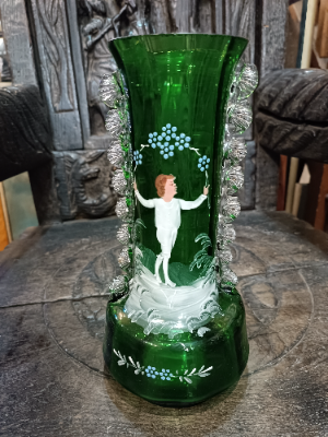 A large Mary Gregory green vase depicting a boy juggling with blue enamel flowers polychrome image.  Size  28 cm high.