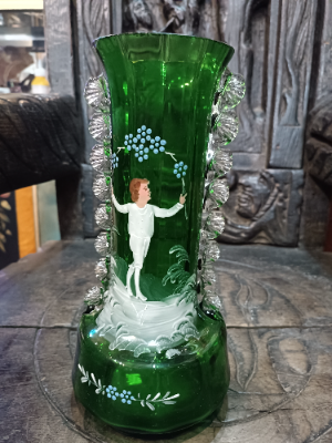 A large Mary Gregory green vase depicting a boy juggling with blue enamel flowers polychrome image.  Size  28 cm high.