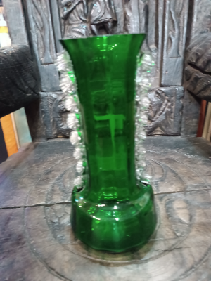 A large Mary Gregory green vase depicting a boy juggling with blue enamel flowers polychrome image.  Size  28 cm high.