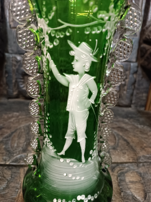 A large Mary Gregory green vase depicting a boy with arm outstretched.
Size 27 cm high.
