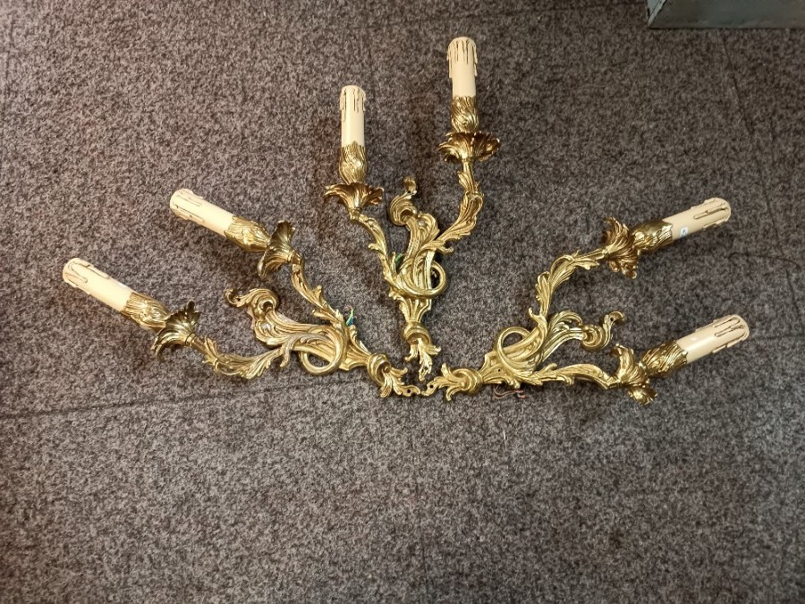 A Set Of Three Rococo Style Gilt Double Wall Lights With Candle Effect Sconces