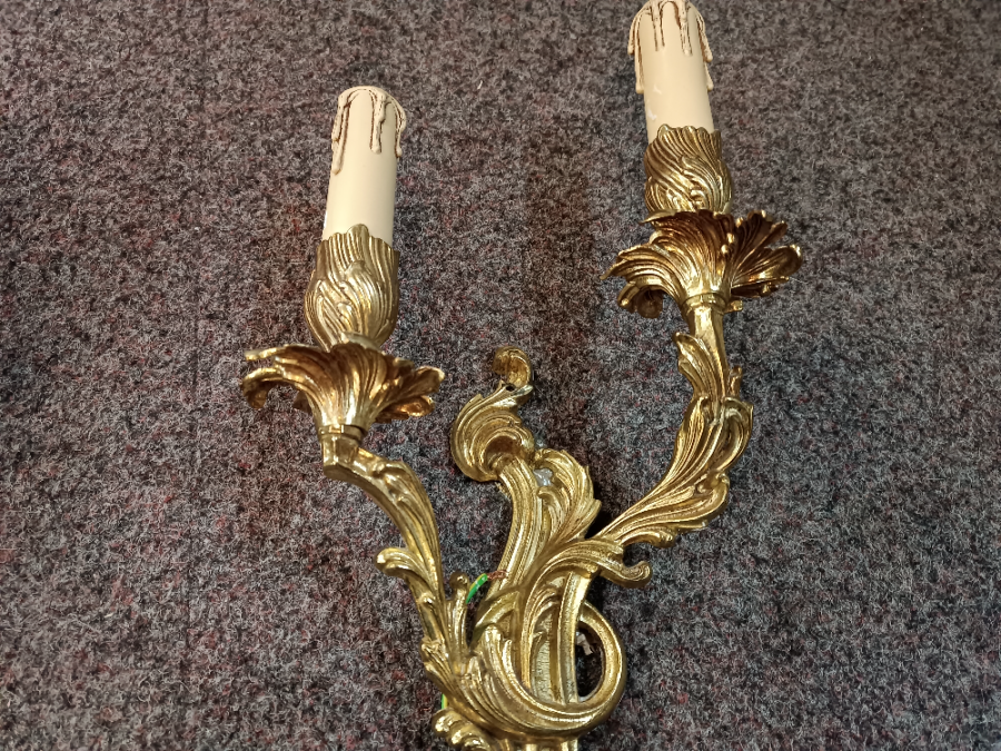 A Set Of Three Rococo Style Gilt Double Wall Lights With Candle Effect Sconces