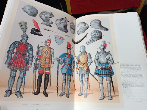A very large hardback book, "The Complete Costume History" by Augustus Recinet. The book filled with elaborate  colourful illustrations from the ancient world to patterns and templates.  Probably 19-20th century.  Good condition.  Size 45 L x 30  W x 7 cm D.