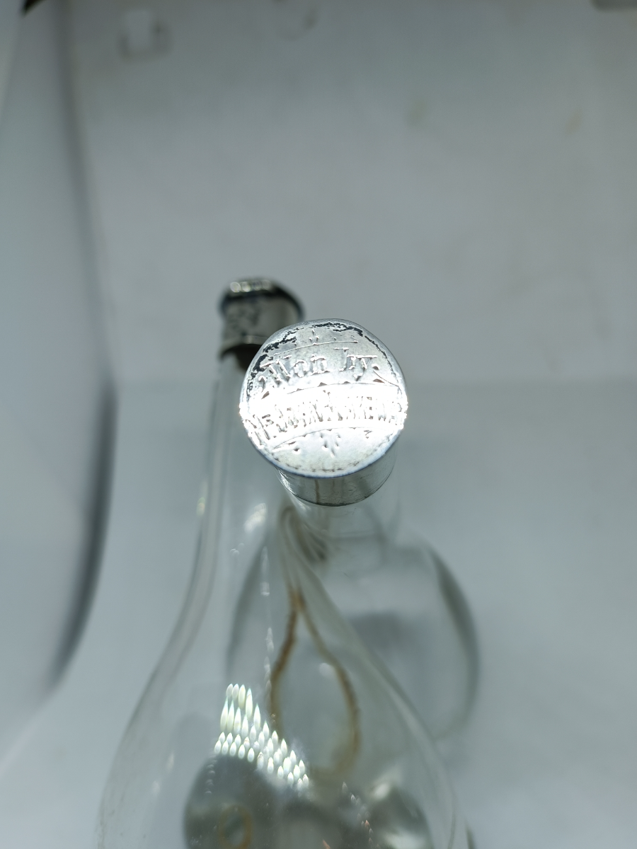 Explore our elegant Edwardian Olive Oil and Vinegar Glass Bottle with Silver Top, hallmarked Birmingham 1910. Order now for a vintage addition to your table setting.