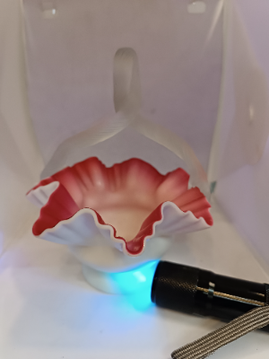 Discover our stunning Victorian Uranium Cased Satin Milk Cranberry Glass bowl with twisted handle. Sized 13cm by 16cm. Shop now to add antique elegance to your décor!