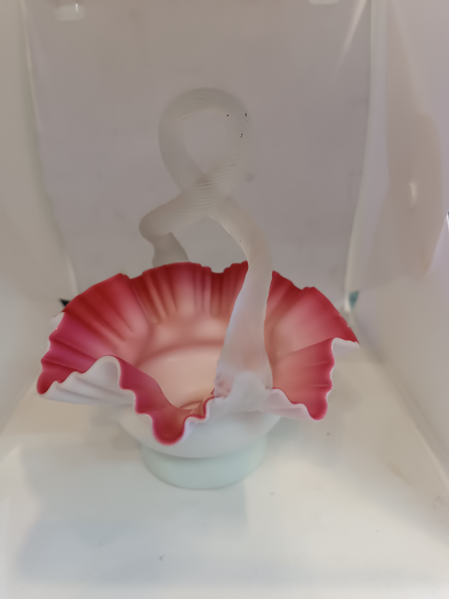 Discover our stunning Victorian Uranium Cased Satin Milk Cranberry Glass bowl with twisted handle. Sized 13cm by 16cm. Shop now to add antique elegance to your décor!