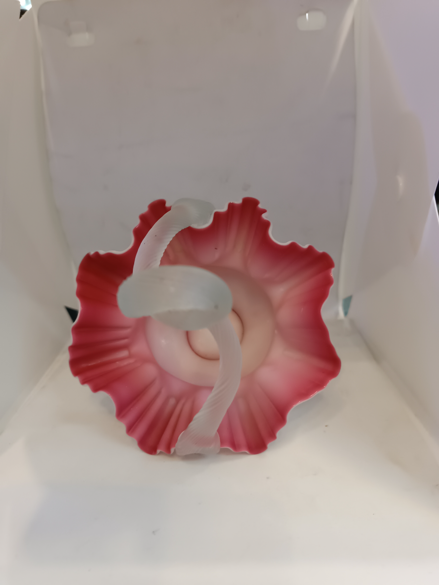 Discover our stunning Victorian Uranium Cased Satin Milk Cranberry Glass bowl with twisted handle. Sized 13cm by 16cm. Shop now to add antique elegance to your décor!