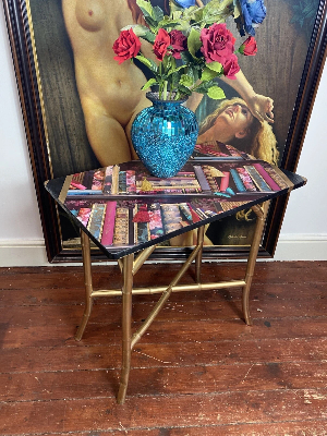 Contemporary Library Montage Hall Table With Bamboo X Frame Stretcher

Circa - Vintage 
Composition - SoftWood Top With Bamboo Stand

Beautiful Rectangular Hall Table With Brightly Coloured Bespoke Library Book Montage Decorative Top In Fuchsia, Cobalt Blue, Red & Gold. An Elegant Oriental Style Base In Gilt Bamboo With X Frame Stretcher Support.

Stunning Showpiece For Eclectic Interior An Eye Catching Ornamental Display.

Dimensions In Inches

Height 29"
Width 30" 
Depth 18" 
Weight Approx 15 KG