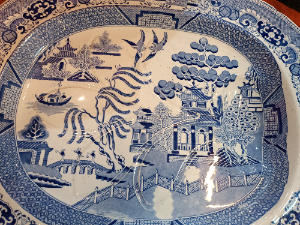 Discover our 19th century Blue Willow pattern meat platter with a unique 'well and tree' design. Shop now for this functional and charming piece of history.