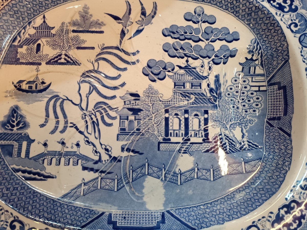 Discover our 19th century Blue Willow pattern meat platter with a unique 'well and tree' design. Shop now for this functional and charming piece of history.