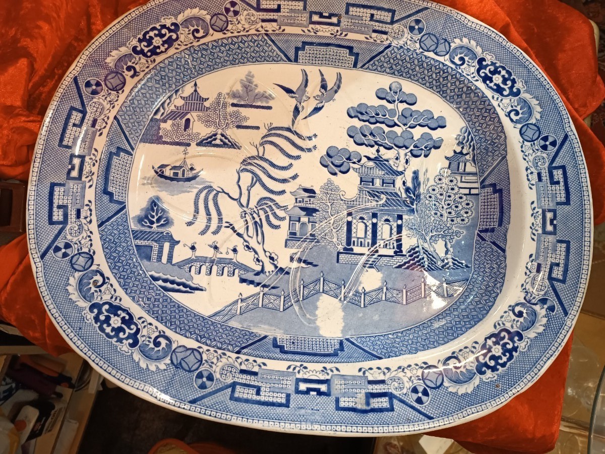 Discover our 19th century Blue Willow pattern meat platter with a unique 'well and tree' design. Shop now for this functional and charming piece of history.