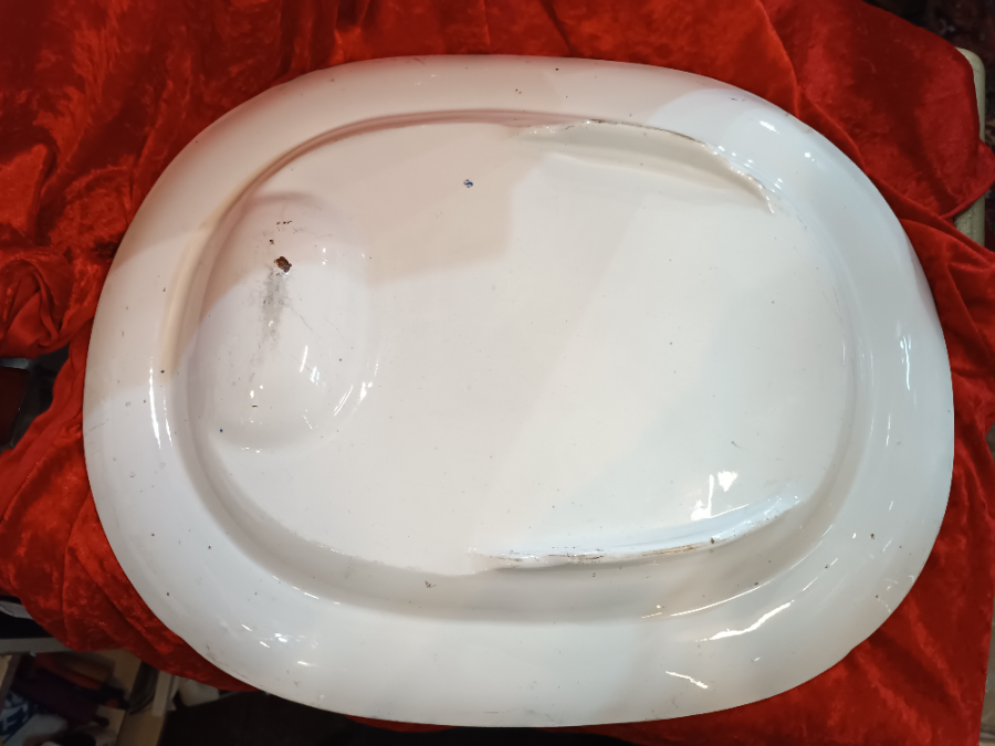 Discover our 19th century Blue Willow pattern meat platter with a unique 'well and tree' design. Shop now for this functional and charming piece of history.