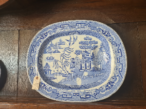 Discover our 19th century Blue Willow pattern meat platter with a unique 'well and tree' design. Shop now for this functional and charming piece of history.