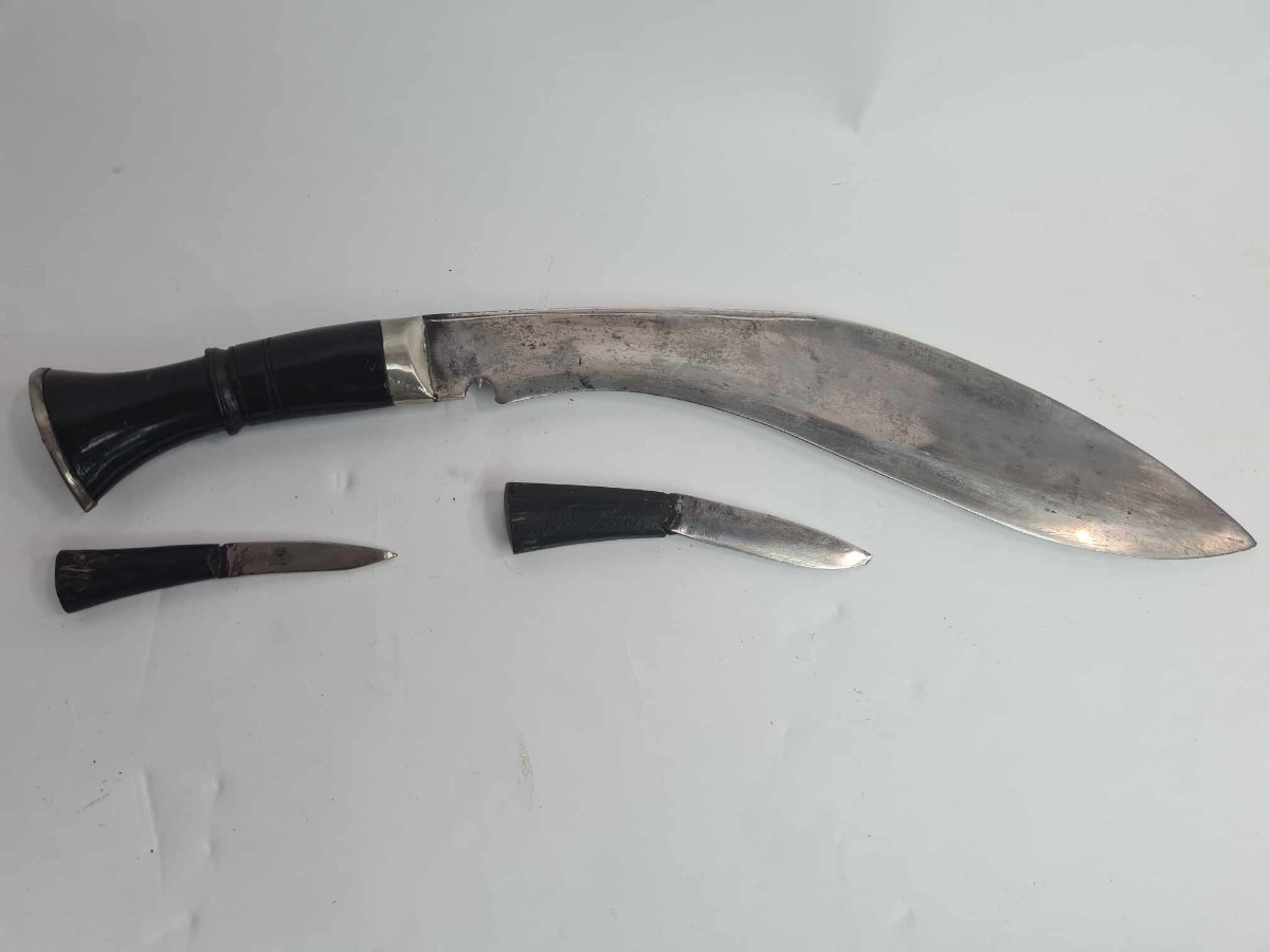 Discover our exceptional range of antique kukris! Experience owning a piece of history with our early to mid 20th-century bone-handled kukri, complete with a black leather sheath and two knives. Shop now!