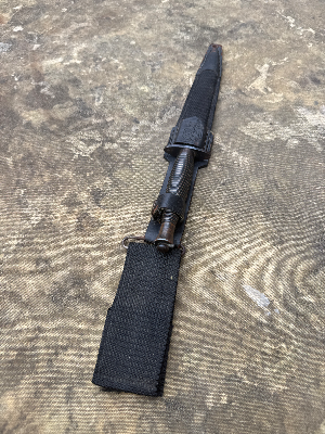 A nice Third Pattern Fairbairn-Sykes example without a heat stamp, suggesting post-war production rather than wartime manufacture. Probably by Wilkinson
 Of particular interest is the sold-out-of-service stamp on the guard, indicating that the knife was formally disposed of from British military stocks and sold to the Indonesian Kopassus Special Forces (due to scabbard being marked Kopassus with the army logo).

This blade appears to be an earlier ex-British Army issue knife, later sold or transferred to Indonesia. It predates the modern Kopassus, which took its present name in the mid-1980s. Indonesia’s Army special forces have much earlier roots in KKAD and later RPKAD (Resimen Para Komando Angkatan Darat), elite commando formations tasked with special operations, reconnaissance, airborne missions and counter-insurgency, often operating in small units in difficult terrain. These predecessor units eventually evolved into today’s Kopassus.

History:

The Third Pattern Fairbairn-Sykes appeared in October 1943 and represented a further simplification of the famous fighting knife for large-scale wartime production.

One of the most recognisable features of the Third Pattern is its redesigned handle, formed with 27 stacked concentric rings. By this stage Wilkinson had moved away from brass, which remained a strategically important material, and instead adopted a less restricted alloy. The grip could be cast in a single operation, reducing the additional remedial machining and finishing required on earlier patterns.

The Third Pattern also introduced the distinctive triangular-shaped ricasso or flat at the rear of the blade, immediately ahead of the guard, another useful identifying feature of the pattern.

As wartime demand increased, elements of manufacture were increasingly outsourced to specialist firms. Companies involved in the production or casting of Third Pattern handles included Wolverhampton Die Casting Company, Walsall Die Casting Ltd, Henry Bar Metal Co. and H. J. Maybry. Handles are often found with numbers or other identifying marks associated with their manufacturer or production source.

A useful rule of thumb when assessing Third Pattern examples concerns the heat-stamped markings commonly encountered on wartime knives. Wartime-produced examples are frequently found with such stamps, while unstamped examples are generally associated with post-war production, although individual knives should always be assessed on the totality of their construction and markings rather than on a single feature alone.