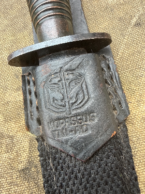 A nice Third Pattern Fairbairn-Sykes example without a heat stamp, suggesting post-war production rather than wartime manufacture. Probably by Wilkinson
 Of particular interest is the sold-out-of-service stamp on the guard, indicating that the knife was formally disposed of from British military stocks and sold to the Indonesian Kopassus Special Forces (due to scabbard being marked Kopassus with the army logo).

This blade appears to be an earlier ex-British Army issue knife, later sold or transferred to Indonesia. It predates the modern Kopassus, which took its present name in the mid-1980s. Indonesia’s Army special forces have much earlier roots in KKAD and later RPKAD (Resimen Para Komando Angkatan Darat), elite commando formations tasked with special operations, reconnaissance, airborne missions and counter-insurgency, often operating in small units in difficult terrain. These predecessor units eventually evolved into today’s Kopassus.

History:

The Third Pattern Fairbairn-Sykes appeared in October 1943 and represented a further simplification of the famous fighting knife for large-scale wartime production.

One of the most recognisable features of the Third Pattern is its redesigned handle, formed with 27 stacked concentric rings. By this stage Wilkinson had moved away from brass, which remained a strategically important material, and instead adopted a less restricted alloy. The grip could be cast in a single operation, reducing the additional remedial machining and finishing required on earlier patterns.

The Third Pattern also introduced the distinctive triangular-shaped ricasso or flat at the rear of the blade, immediately ahead of the guard, another useful identifying feature of the pattern.

As wartime demand increased, elements of manufacture were increasingly outsourced to specialist firms. Companies involved in the production or casting of Third Pattern handles included Wolverhampton Die Casting Company, Walsall Die Casting Ltd, Henry Bar Metal Co. and H. J. Maybry. Handles are often found with numbers or other identifying marks associated with their manufacturer or production source.

A useful rule of thumb when assessing Third Pattern examples concerns the heat-stamped markings commonly encountered on wartime knives. Wartime-produced examples are frequently found with such stamps, while unstamped examples are generally associated with post-war production, although individual knives should always be assessed on the totality of their construction and markings rather than on a single feature alone.