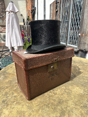A lovely late Victorian top hat (Queens Crown) with later top hat case, named. Missing a key for the case.