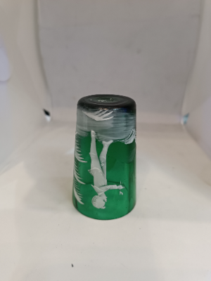 Discover the exquisite Mary Gregory emerald green shot tumbler glass. Perfect condition and featuring a unique design. Dive into antique elegance now.