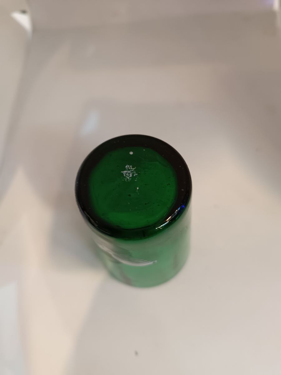 Discover the exquisite Mary Gregory emerald green shot tumbler glass. Perfect condition and featuring a unique design. Dive into antique elegance now.