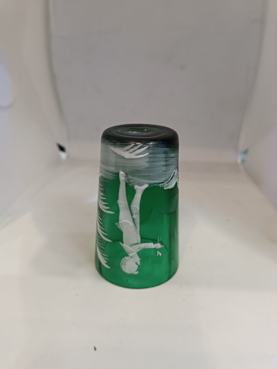 Discover the exquisite Mary Gregory emerald green shot tumbler glass. Perfect condition and featuring a unique design. Dive into antique elegance now.