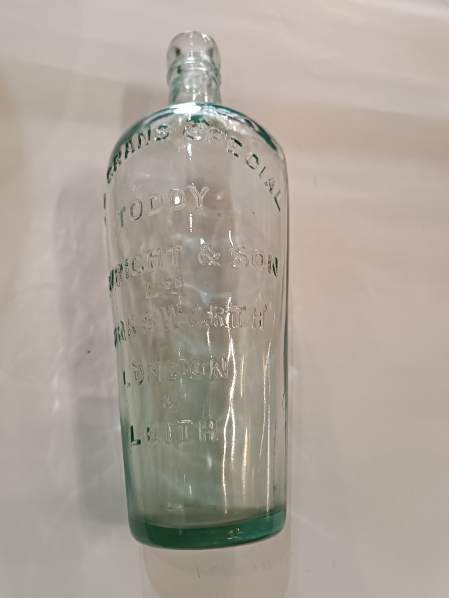 Discover a 19th-century Toddy Bottle by C. Wright & Son Ltd, London. This unique piece is 10 inches tall, perfect for mixing spirits and sugar. Shop now for quality antiques!