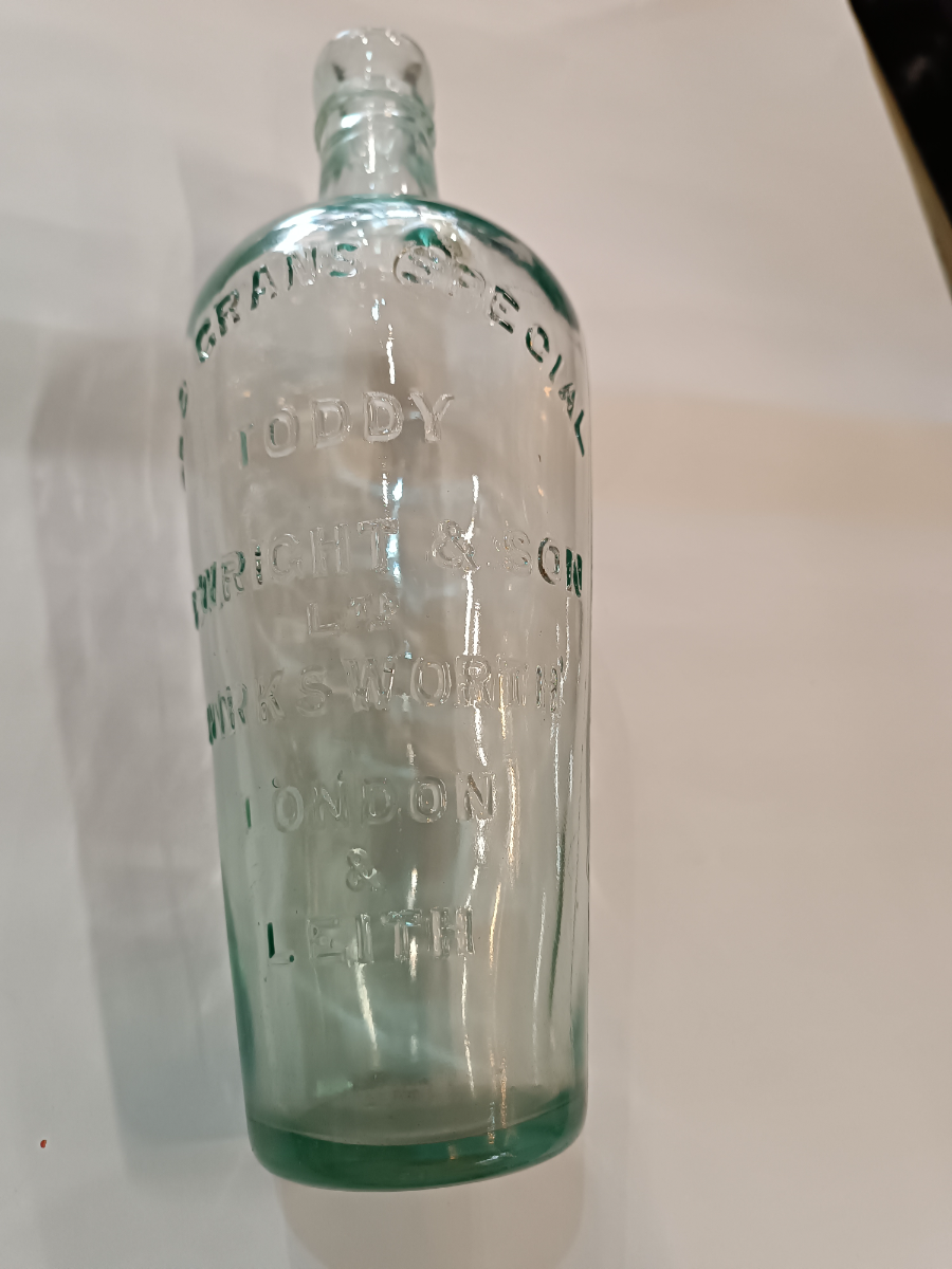 Discover a 19th-century Toddy Bottle by C. Wright & Son Ltd, London. This unique piece is 10 inches tall, perfect for mixing spirits and sugar. Shop now for quality antiques!