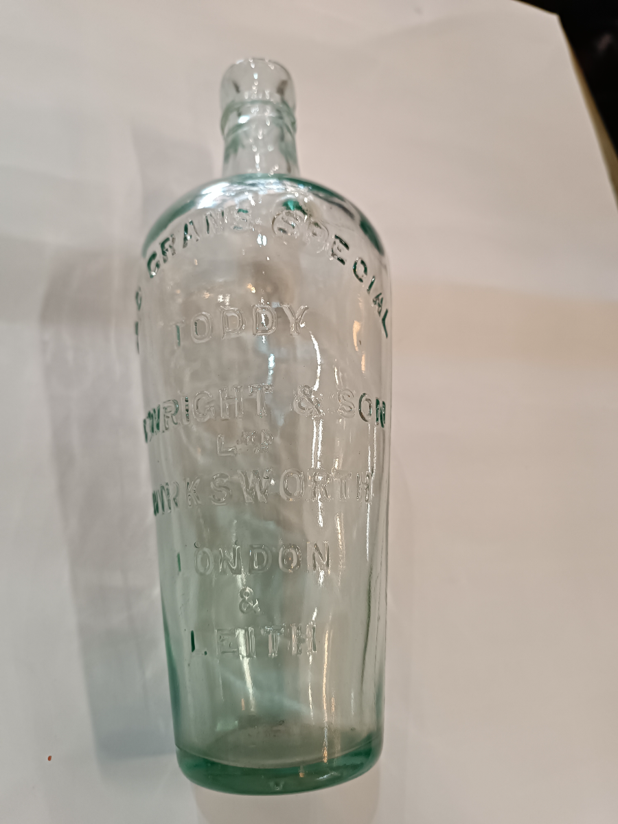 Discover a 19th-century Toddy Bottle by C. Wright & Son Ltd, London. This unique piece is 10 inches tall, perfect for mixing spirits and sugar. Shop now for quality antiques!