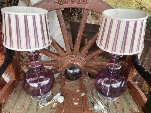 A stylish pair of brown glass table lamps, each featuring an elegant double-curved neck with tinted glass detailing, set upon a rounded glass base.

The lamps are complemented by designer striped silk shades, creating a sophisticated and decorative look. Both lamps have been PAT tested for electrical safety.

The shades are described as reproduction/vintage style and measure approximately 22 cm high × 26 cm diameter.

Overall lamp dimensions: approximately 59 cm high × 26 cm wide
Price: £395 for the pair
UK delivery: £40