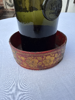 A lovely pair of Regency red paper mache bottle coasters. Circa 1810. As seen condition. Sealed bottle not included.