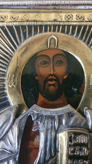 Discover the timeless beauty of our Russian Icon of Christ Pantocrator. Believed to be silver, this religious artifact enchants with its classic scripture-holding depiction. Explore now and make this vintage 19th Century treasure yours!