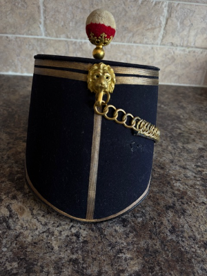 Object:
1869 Pattern 24th Regiment of Foot Shako, owned by George Frederick Hodson.

Provenance:
This shako belonged to George Frederick John Hodson from Bray County, Wicklow. He served in Captain Reginald Younghusbands Company C at Isandhlwana, positioned on the left of the line. His group were the last to perish at this battles conclusion. Its thought that either Hodson or Younghusband made the final, desperate bayonet charge, attempting to slay as many enemies as possible before an inevitable death by assegai. The provided photo displays Hodson in full-dress lieutenants uniform, during his tenure as Assistant to Sir Henry Bartle Frere.

Condition:
The item remains in mint condition - a truly once-in-a-lifetime opportunity.