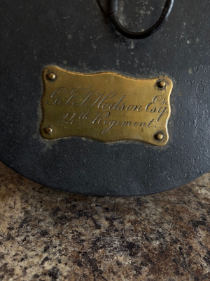 Object:
1869 Pattern 24th Regiment of Foot Shako, owned by George Frederick Hodson.

Provenance:
This shako belonged to George Frederick John Hodson from Bray County, Wicklow. He served in Captain Reginald Younghusbands Company C at Isandhlwana, positioned on the left of the line. His group were the last to perish at this battles conclusion. Its thought that either Hodson or Younghusband made the final, desperate bayonet charge, attempting to slay as many enemies as possible before an inevitable death by assegai. The provided photo displays Hodson in full-dress lieutenants uniform, during his tenure as Assistant to Sir Henry Bartle Frere.

Condition:
The item remains in mint condition - a truly once-in-a-lifetime opportunity.
