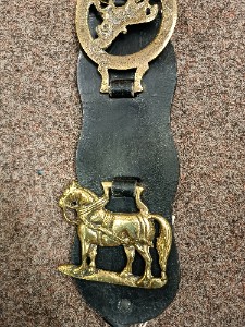 A vintage leather strap containing 4 horse brasses, late 19- early 20th century, also came from one equestrian family.  Size. 43 cm long.