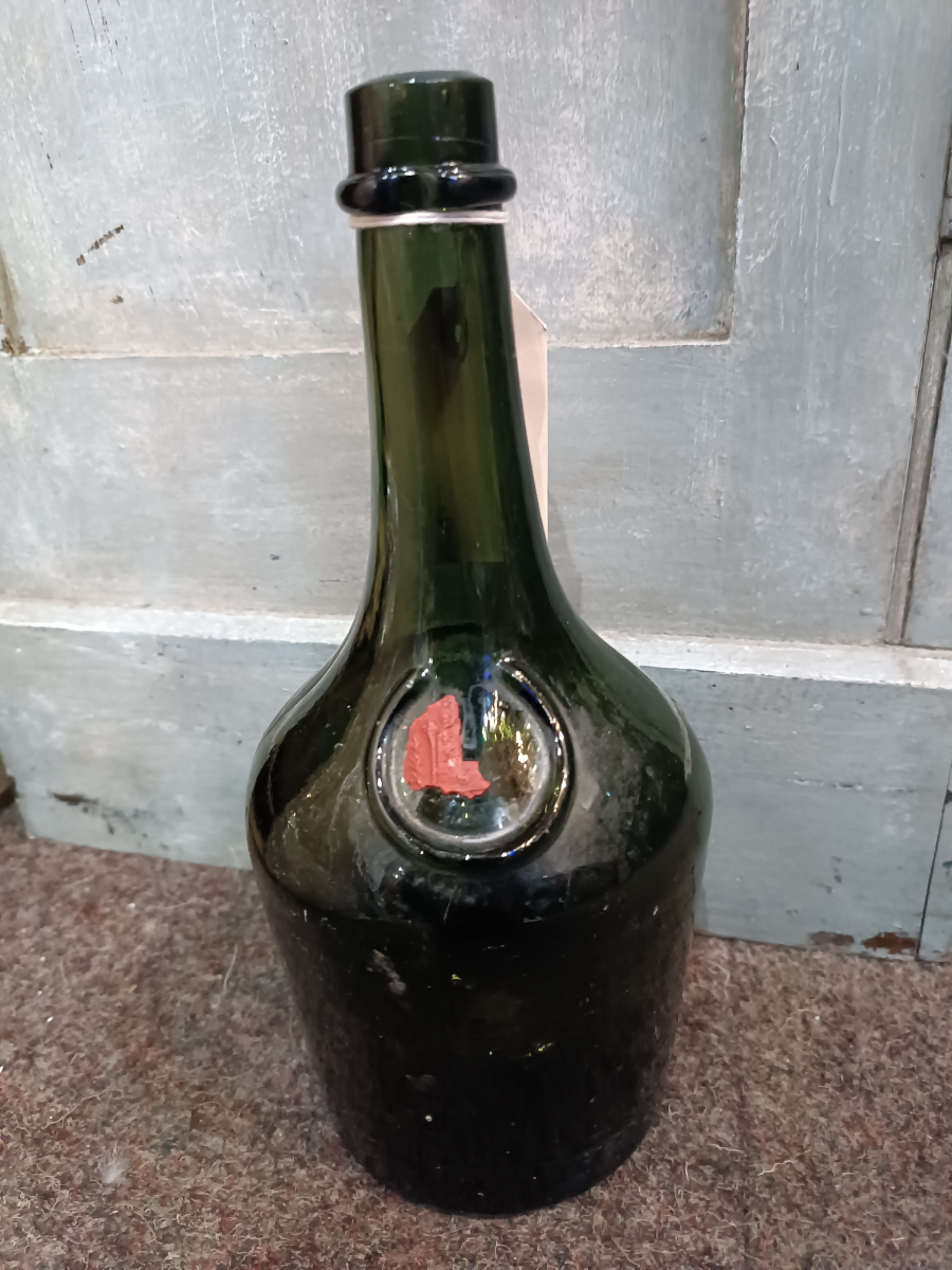 Discover our rare 1890-1910 French Benedictine glass bottle with a wax seal. At 27 cm tall it's a must for any collector. Shop now for antique treasures!