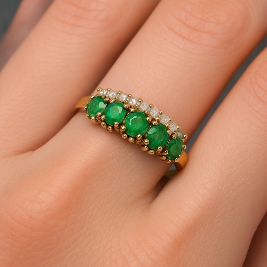 Discover our 9ct gold ring, studded with emeralds and diamonds. Expertly crafted in Sheffield. Weighs 2.9g, size N. Shop now to add a touch of luxury to your collection.