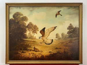 Original large oil painting on canvas, signed by artist G Millhouse in the bottom right corner. The painting depicts a pair of kestrels hunting in unison across an open landscape, with one swooping down towards a large rodent while the other flies overhead. Warm earth tones and golds, delicate brushwork and fine attention to detail bring the birds and surrounding landscape to life. Presented in an ornate gilt frame. Dimensions: 31.5 inches high × 39.5 inches wide.