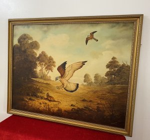 Original large oil painting on canvas, signed by artist G Millhouse in the bottom right corner. The painting depicts a pair of kestrels hunting in unison across an open landscape, with one swooping down towards a large rodent while the other flies overhead. Warm earth tones and golds, delicate brushwork and fine attention to detail bring the birds and surrounding landscape to life. Presented in an ornate gilt frame. Dimensions: 31.5 inches high × 39.5 inches wide.