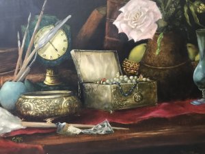 Original vintage still-life oil painting on canvas, signed with the artist’s initials C.M.P. The composition depicts a jewel casket, French clock, leather-bound books, pink rose, artist’s oil paint and brush, and a green glass vase arranged on a table. Vibrant colours and fine detail enrich the scene, presented in an ornate carved giltwood frame. Dimensions: 24 inches high × 30.5 inches wide.